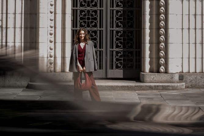 Simona geht vor einer Altstadtfassade, im Vordergrund verwischte Bewegung